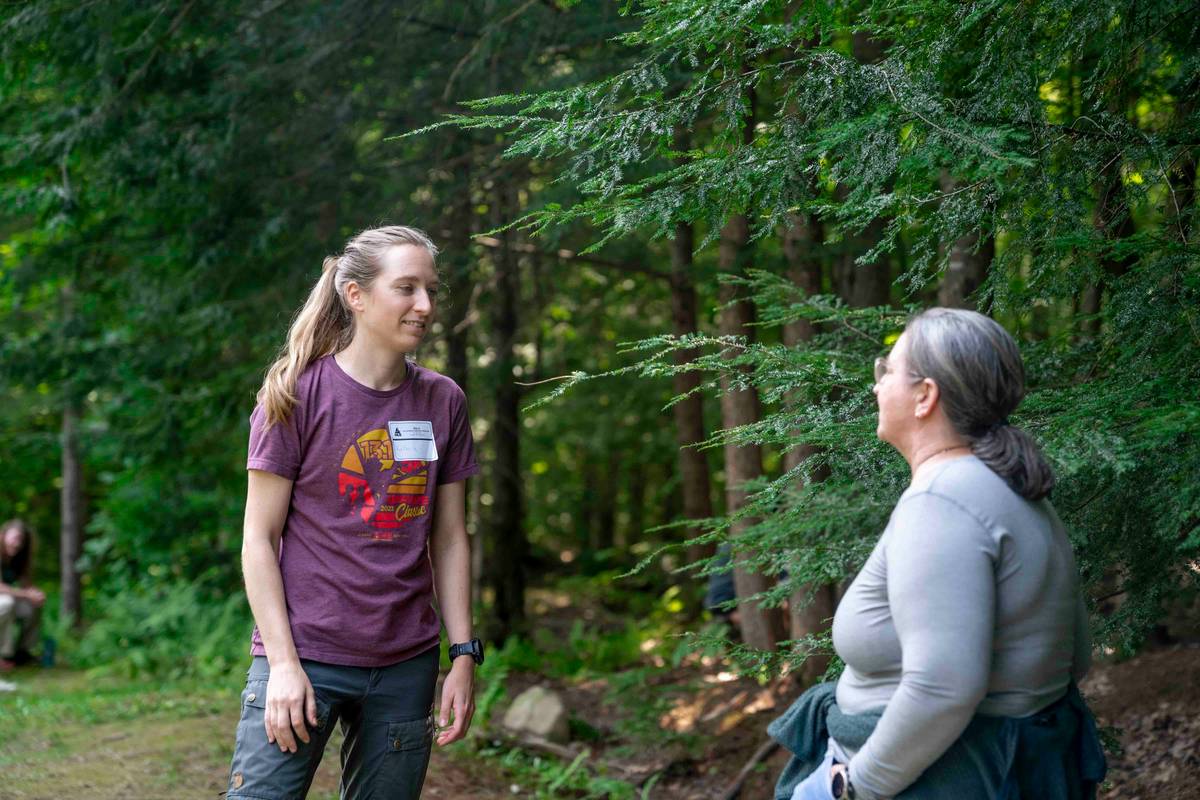 A group of friends enjoying a hike together through forest paths