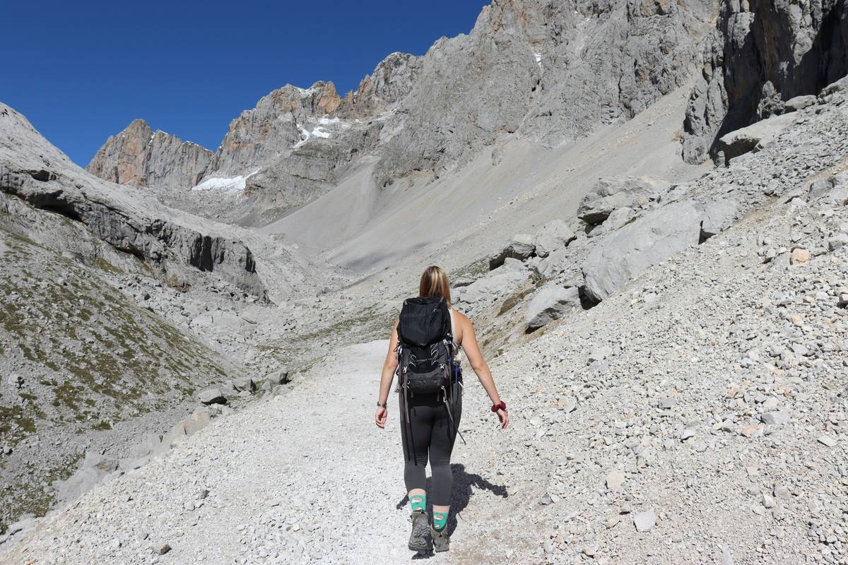 Woman checking her smartwatch mid-hike