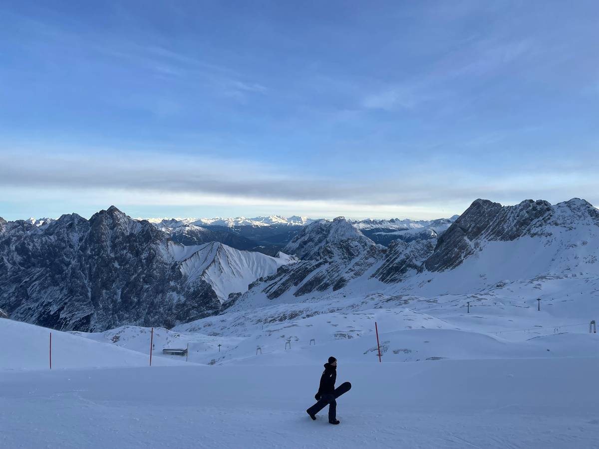 A scenic hiking trail surrounded by trees and sunlight