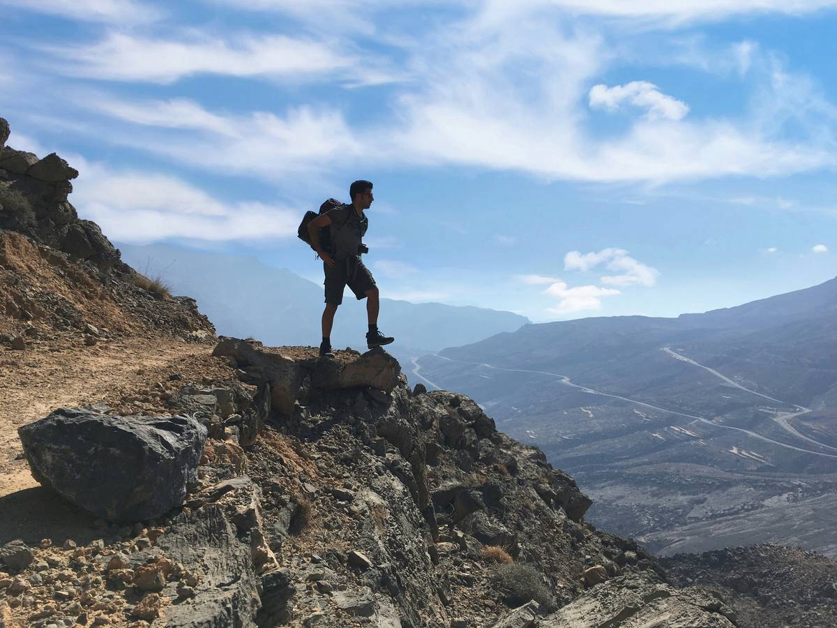 Close-up shot of hiking boots, backpack, and water bottle