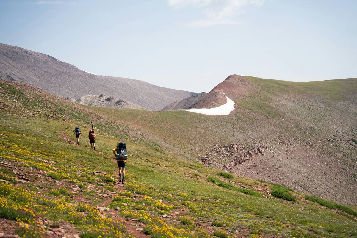 Hiker on a scenic ridge trail during sunset