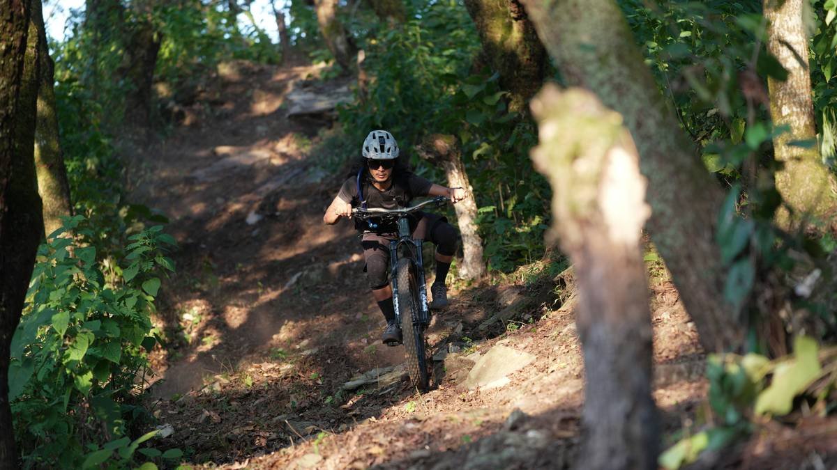 A hiker standing on a mountain ridge during sunrise