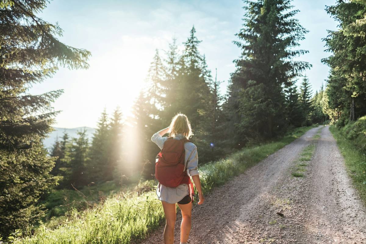 Before/after photos of woman hiking in same spot, 12 weeks apart—noticeable leaner legs and improved posture