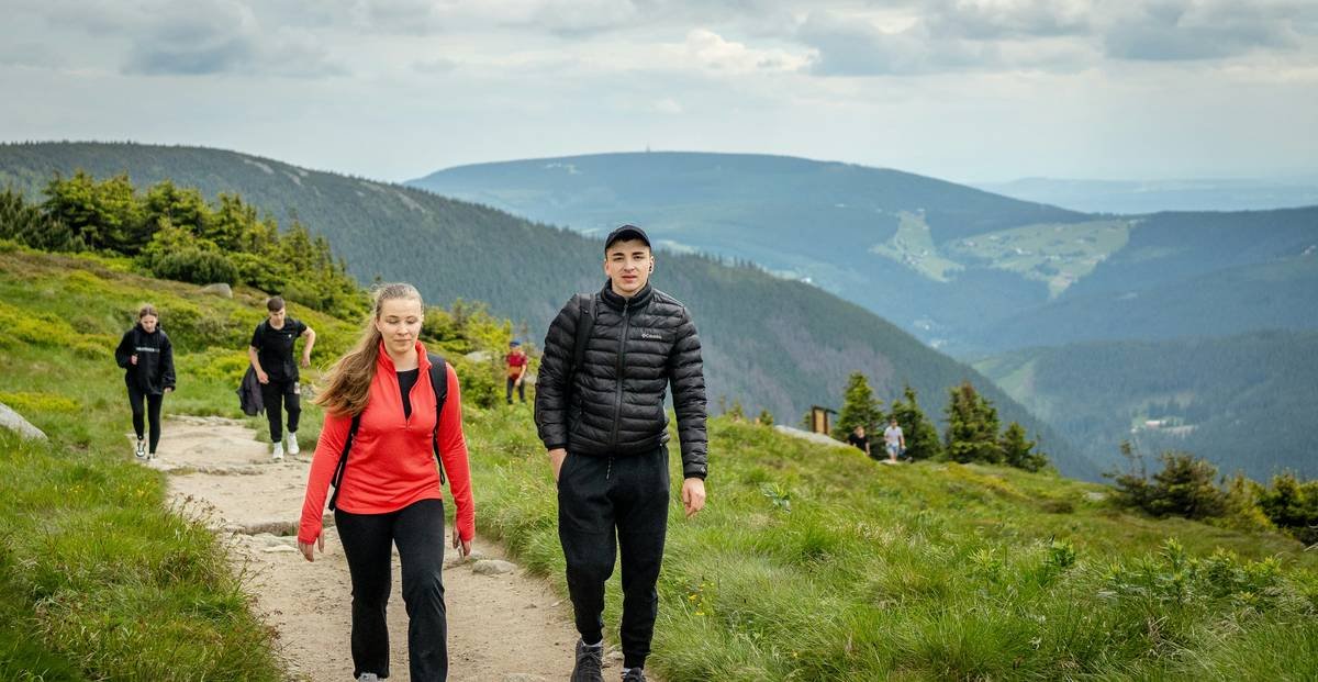 Before-and-after photos of Maya: left in office clothes looking tired, right smiling on mountain trail in athletic wear