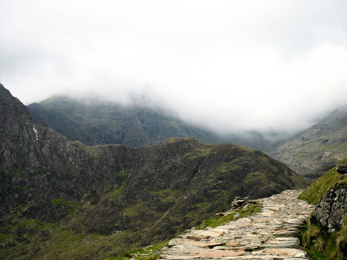 Woman hiking steep trail during morning fast for nature walk hiking how to lose
